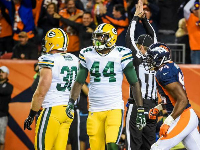 Green Bay Packers fullback John Kuhn (30) (top) is hit by New York